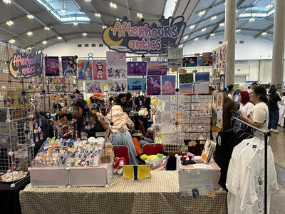 Our booth display on day 2, with Lin behind the table.